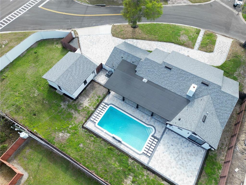 A single-story house with white stucco walls, a gray shingled roof, and black window trim — 2801 WAUMPI TRAIL, MAITLAND, FL
