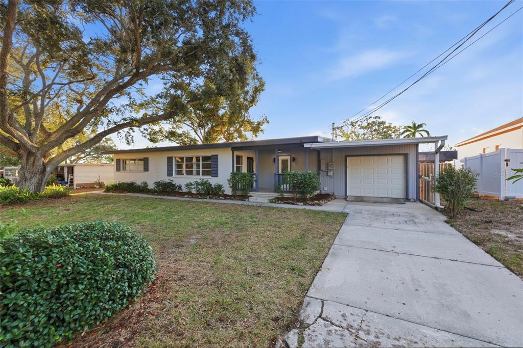 A single-story house with a white exterior, a front porch, and an attached one-car garage — 7198 121ST WAY, SEMINOLE, FL