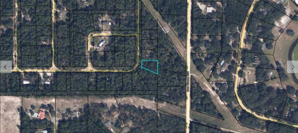 This is an aerial map showing a highlighted vacant lot in a wooded residential area — 7231 LEHIGH DRIVE, KEYSTONE HEIGHTS, FL