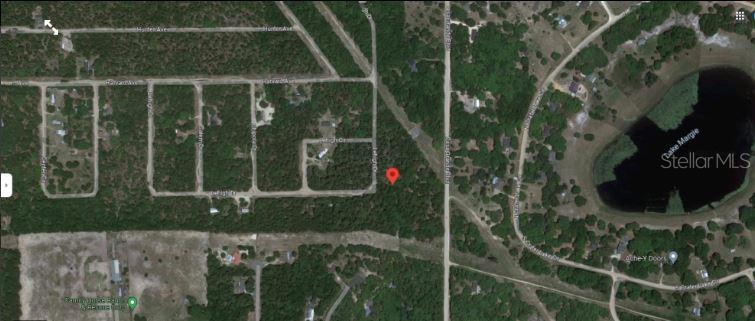 This is a satellite map view showing a wooded lot marked with a red pin — 7231 LEHIGH DRIVE, KEYSTONE HEIGHTS, FL