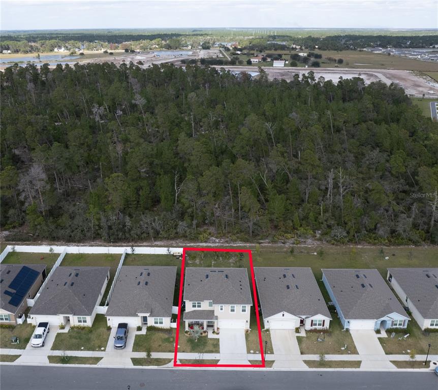 An aerial view shows a two-story house with a red outline on its property lot — 2540 HARMONIA HAMMOCK ROAD, HARMONY, FL
