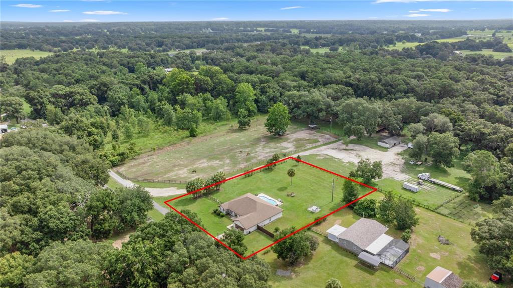 An aerial view shows a house with a pool inside a red-outlined property boundary — 13783 SE 8TH COURT, OCALA, FL