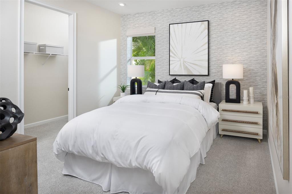 A bedroom features a white bed, textured wallpaper, two bedside lamps, and an open closet — 11423 BOUNDLESS TERRACE, VENICE, FL