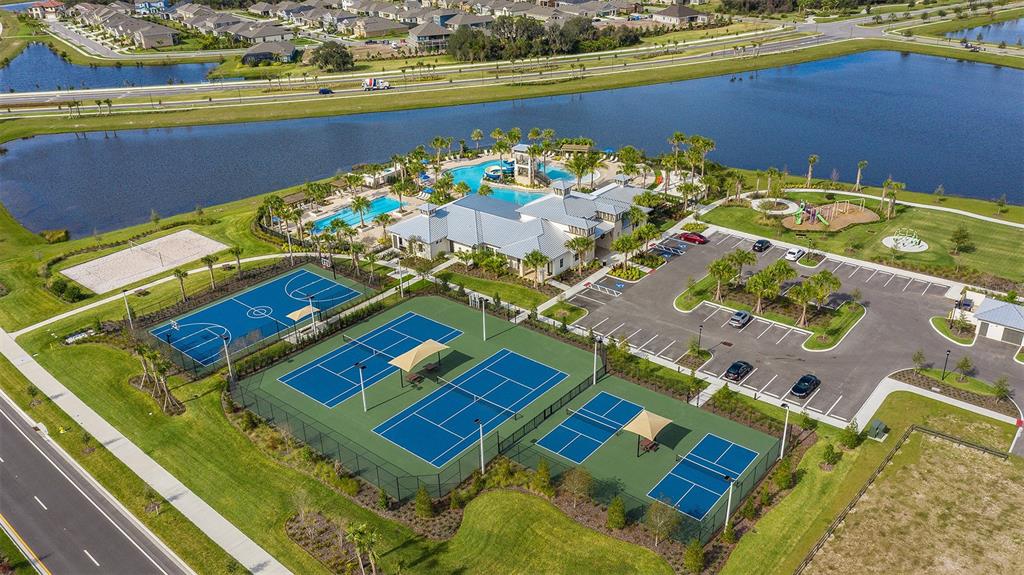 An aerial view of a community amenity center featuring swimming pools, tennis courts, and parking — 5316 SPRING MAIDEN CIRCLE, APOLLO BEACH, FL