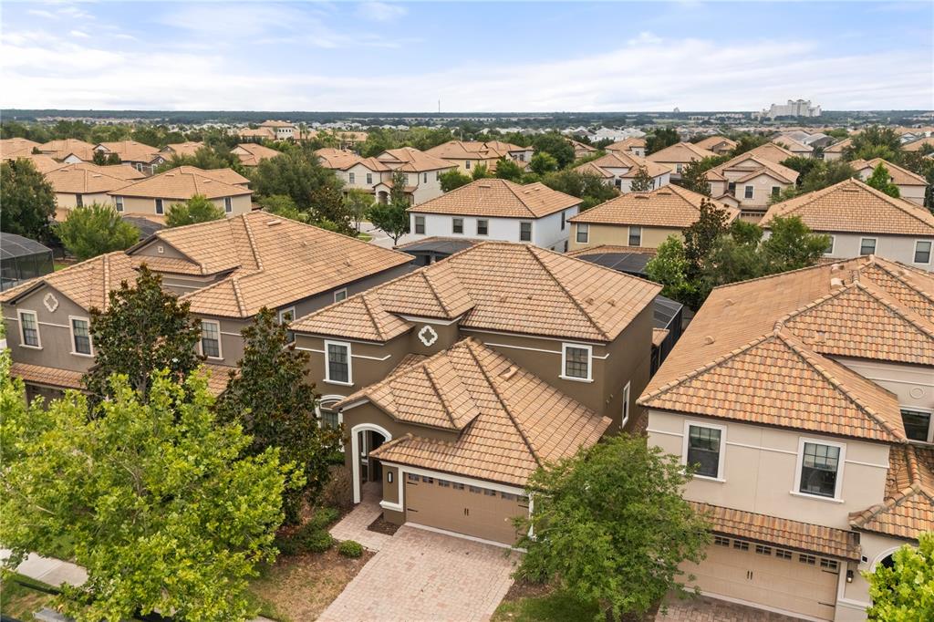 An aerial view shows a suburban neighborhood with multiple two-story houses featuring tan tile roofs — 1423 THUNDERBIRD ROAD, DAVENPORT, FL