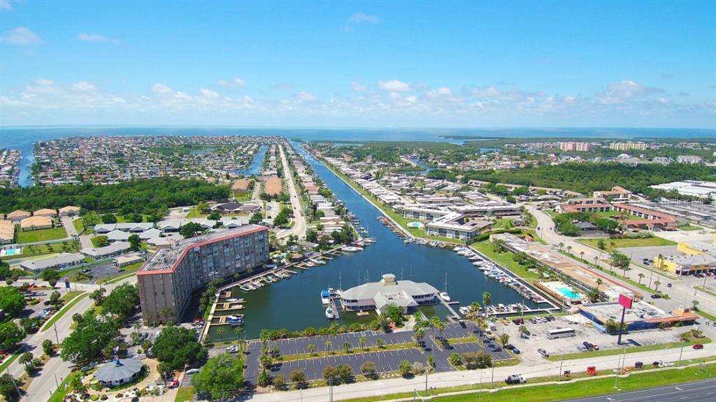 An aerial view of a waterfront apartment complex with a marina and parking lot — 5015 US HIGHWAY 19 UNIT 201, NEW PORT RICHEY, FL