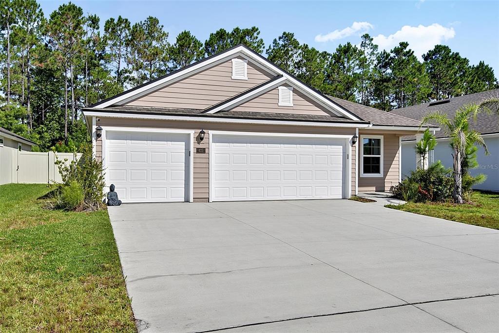 A tan, single-story house with a three-car garage and a concrete driveway — 425 NARVAREZ AVENUE, ST AUGUSTINE, FL