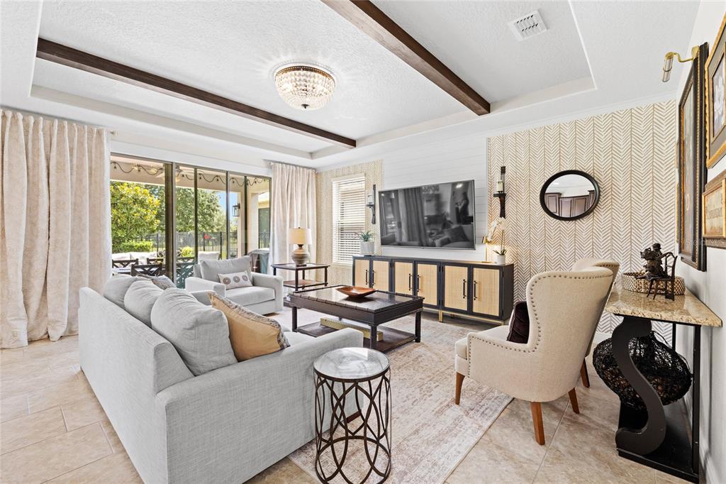 An entryway features a staircase with dark wood treads, tile flooring, and a white front door — 15671 MARINA BAY DRIVE, WINTER GARDEN, FL
