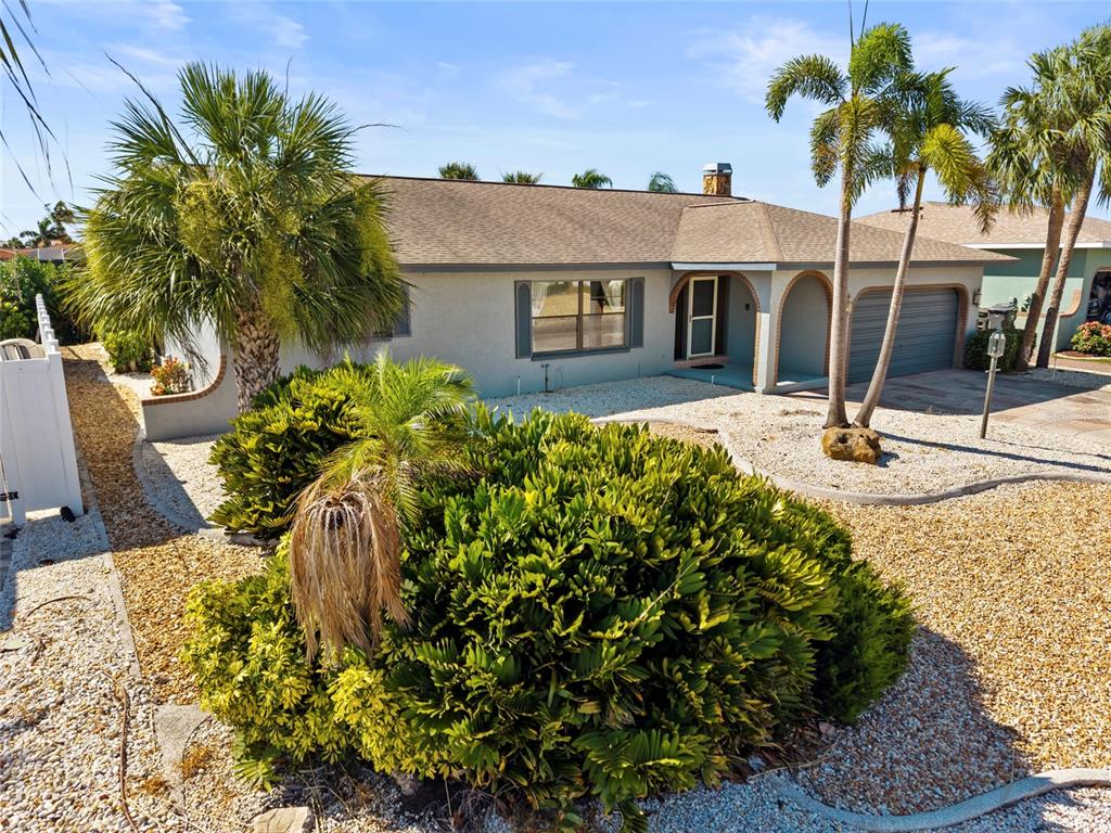 A view through a sliding glass door reveals a pool, patio, and canal — 921 BIRDIE WAY, APOLLO BEACH, FL