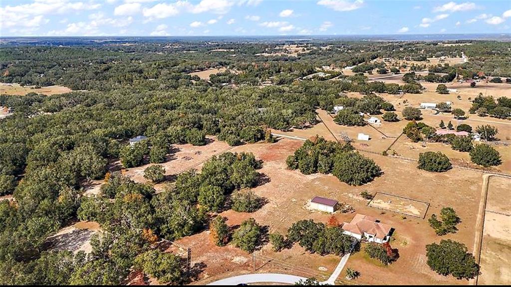 An aerial view shows a house with a detached garage on a large, rural lot — SWEETWOOD LANE, CLERMONT, FL