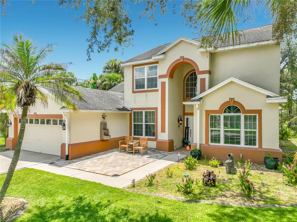 A two-story house with a paved front patio, a garage, and a landscaped front yard — 1756 BRANCHWATER TRAIL, ORLANDO, FL