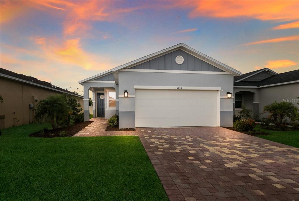 A single-story house with a gray exterior, a two-car garage, and a paved driveway — 2652 89TH STREET CIRCLE E, PALMETTO, FL