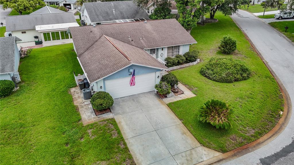 An aerial view of a single-story house with a light blue exterior and a garage — 8045 PASADENA DRIVE, PORT RICHEY, FL