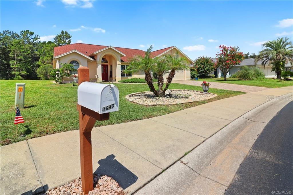 A single-story house with a red roof, tan exterior, and a mailbox in the foreground — 3640 E HIDDEN COVE TRAIL, HERNANDO, FL