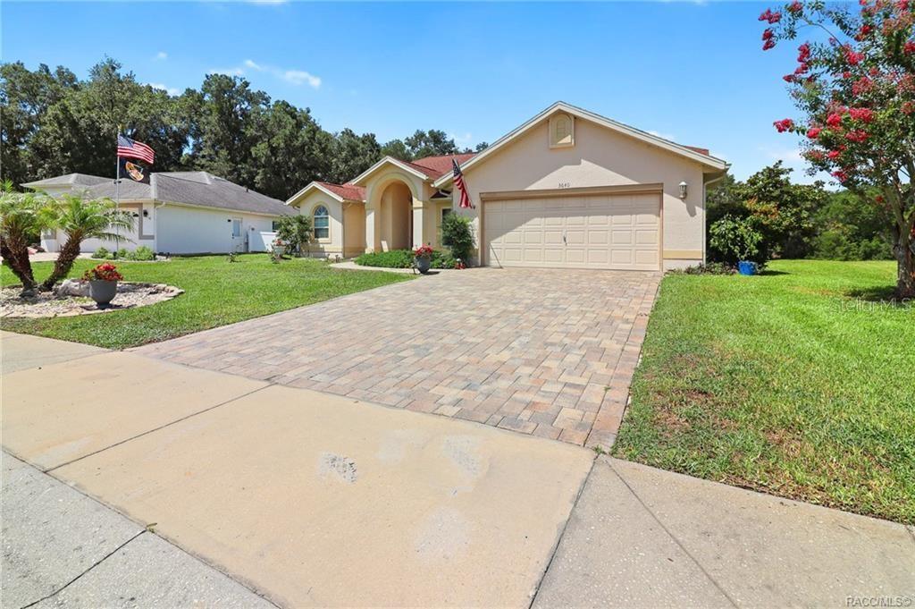 A single-story house with a paved driveway, a two-car garage, and a front lawn — 3640 E HIDDEN COVE TRAIL, HERNANDO, FL