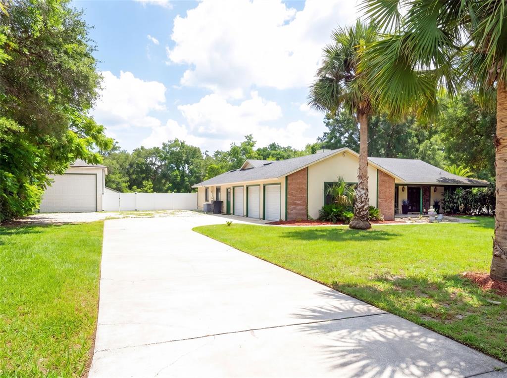A single-story brick house with a palm tree in the front yard at sunset — 3501 HILL STREAM AVENUE, APOPKA, FL
