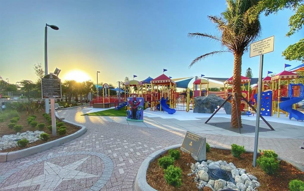 A sunny outdoor playground features colorful climbing structures, slides, and paved walkways with landscaping — 336 S LIME AVENUE, SARASOTA, FL