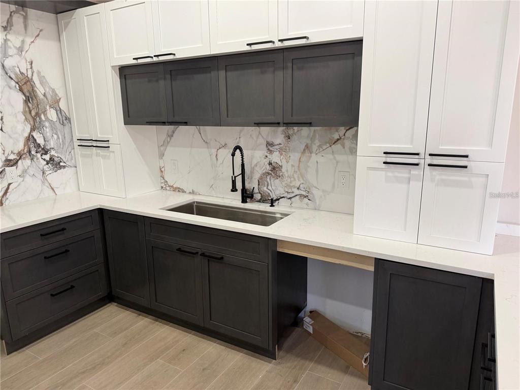 A modern bathroom features a floating wood vanity with double sinks and two rectangular mirrors — 47 BRIG CIRCLE E, PLACIDA, FL