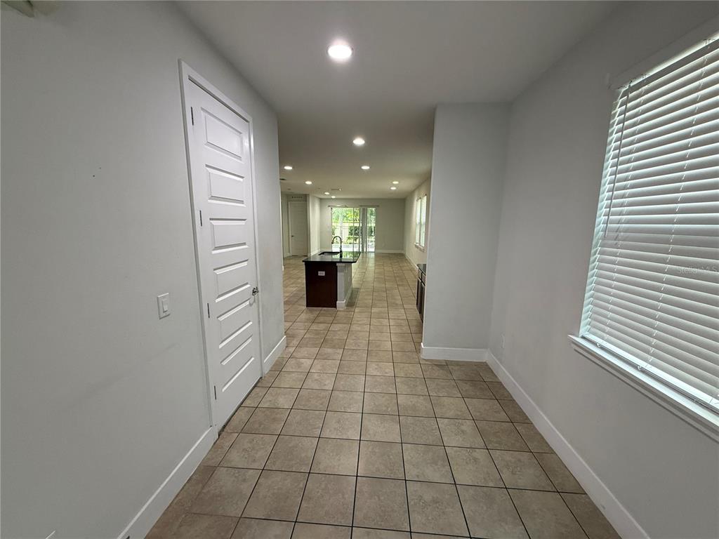 A swimming pool and hot tub sit on a paved patio at sunset with palm trees — 481 LASSO DRIVE, KISSIMMEE, FL