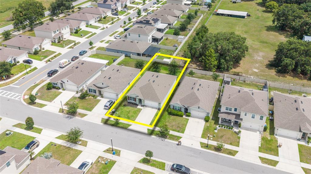 An aerial view shows a suburban neighborhood with a highlighted single-family home and yard — 5274 MAYOR DRIVE, ST CLOUD, FL