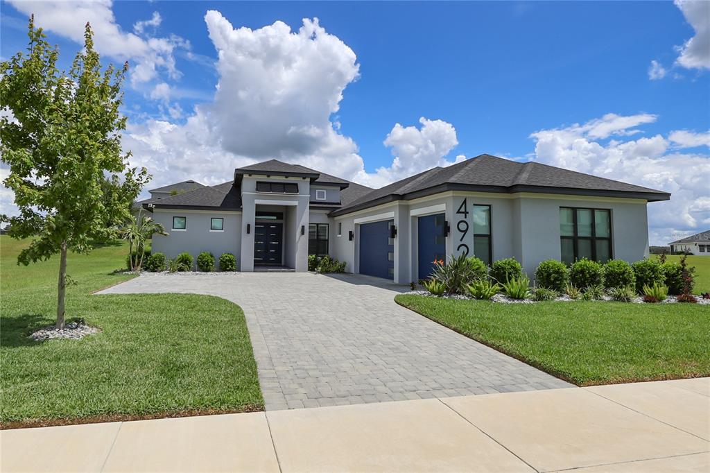 This is a floor plan of a single-story house featuring four bedrooms, a garage, and lanai — 492 ADAMS VIEW LANE, AUBURNDALE, FL