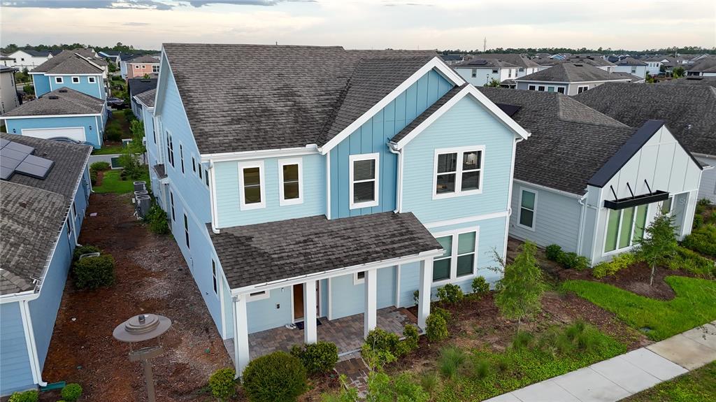 An aerial view of a two-story light blue house with a covered front porch — 6518 WINDING PATH WAY, ST CLOUD, FL