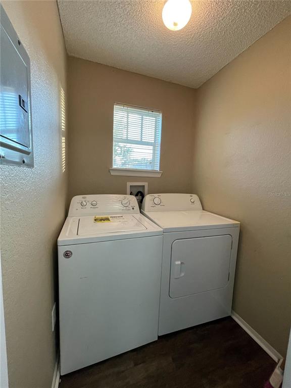 A laundry room features a white top-load washer and dryer beneath a window — 2202 KEY WEST COURT UNIT 616, KISSIMMEE, FL