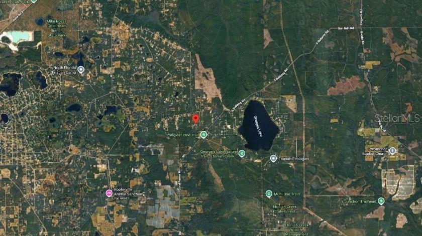 This is an aerial map showing a rural area with forests, lakes, and local trails — CENTERWOOD ROAD, FLORAHOME, FL