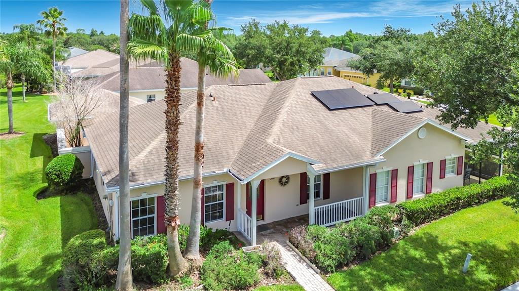 A single-story house with a tan exterior, a red front door, and a paved walkway — 278 ANASTASIA DRIVE, KISSIMMEE, FL