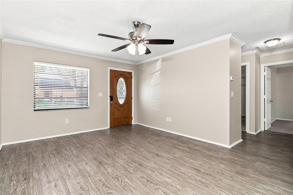 A bathroom features a pedestal sink, a toilet, and a shower-tub combination with white tiles — 8305 AUTUMN OAK AVENUE, PORT RICHEY, FL