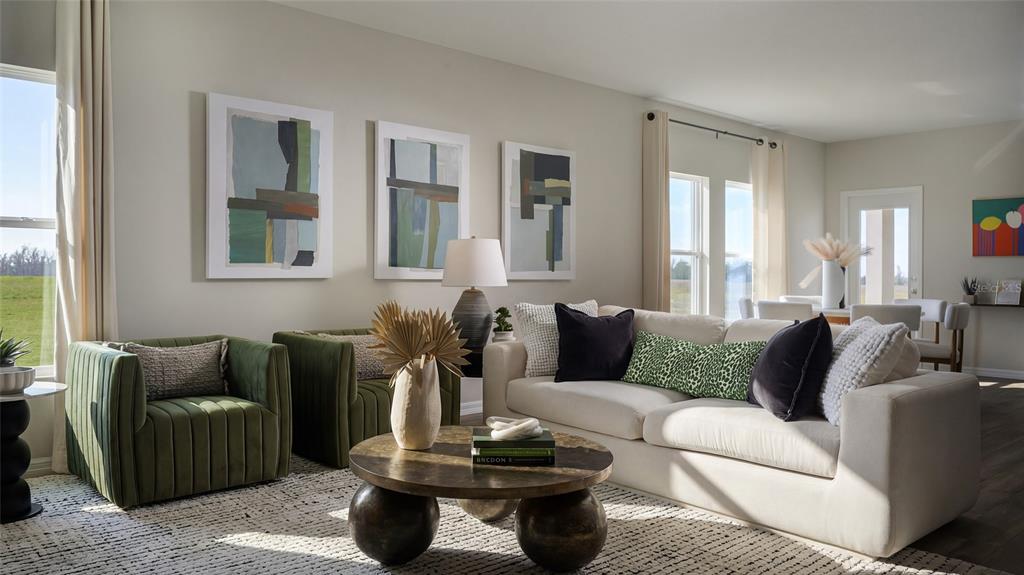 A living room features two green velvet chairs, a beige sofa, and a round coffee table — 9162 BENT BRANCH, DADE CITY, FL