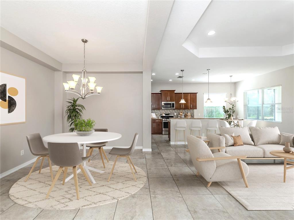 An open-concept dining area and living room with tile flooring and a modern kitchen — 11406 BELVEDERE TERRACE, BRADENTON, FL