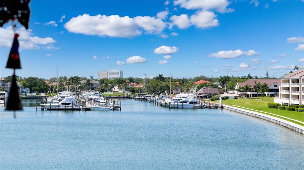 A view of a marina with docked boats and surrounding buildings under a blue sky — 2775 KIPPS COLONY DRIVE S UNIT 305, GULFPORT, FL