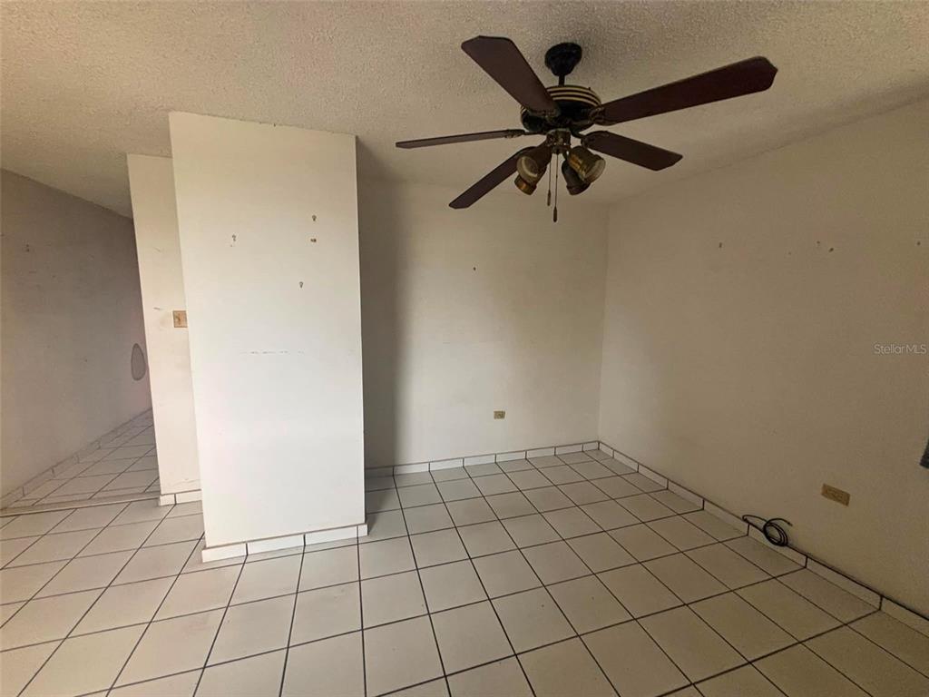 An empty room with white walls, white tile flooring, and a ceiling fan — 81 Mayaguez Street Apt 32 CONDO FRENCH PLAZA UNIT 327, SAN JUAN, PR