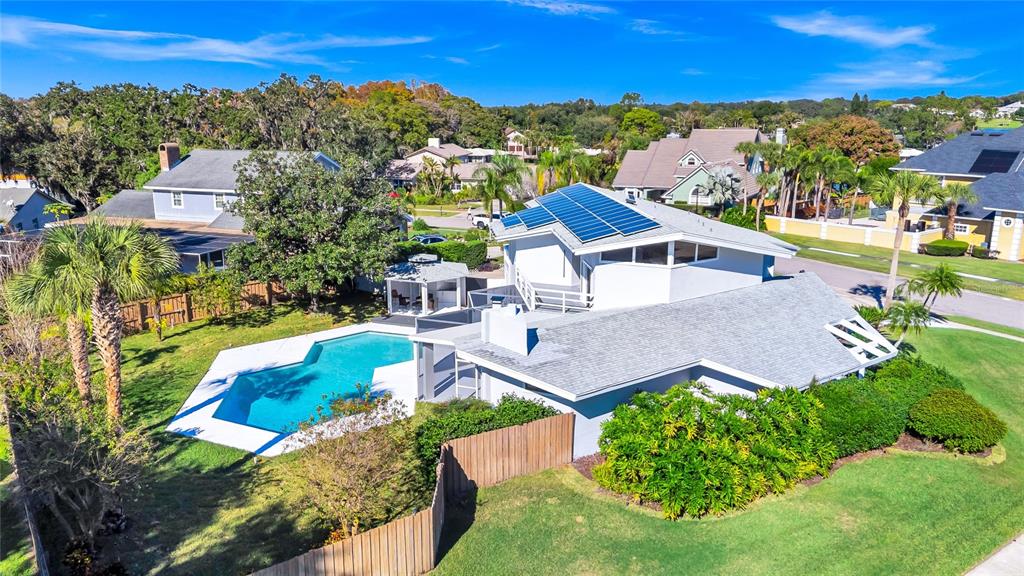 An aerial view of a house with a swimming pool, solar panels, and a gazebo — 8922 BAY COVE COURT, ORLANDO, FL