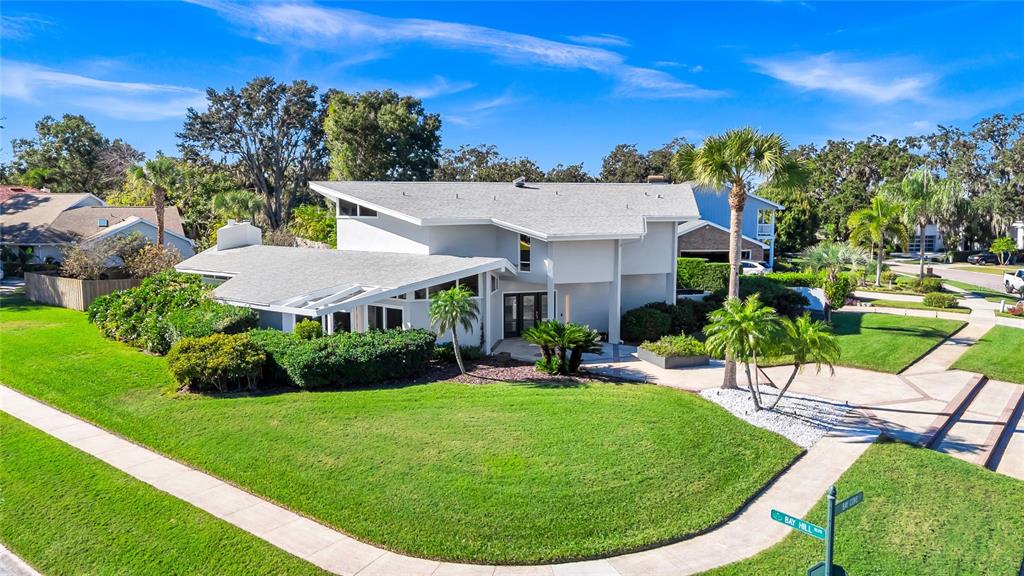 An exterior view of a modern two-story house with a gray roof and landscaped lawn — 8922 BAY COVE COURT, ORLANDO, FL