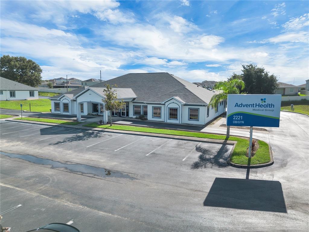 An exterior view of a single-story medical office building with a parking lot and signage — 2221 NORTH BOULEVARD W, DAVENPORT, FL