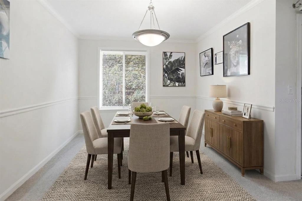 A dining room features a wooden table with six chairs, a sideboard, and a pendant light — 8880 OLD KINGS ROAD S UNIT 4, JACKSONVILLE, FL