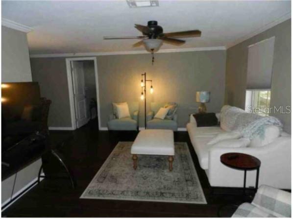 A living room features dark wood floors, a white sofa, two armchairs, and a ceiling fan — 751 ARABIAN CIRCLE, NOKOMIS, FL