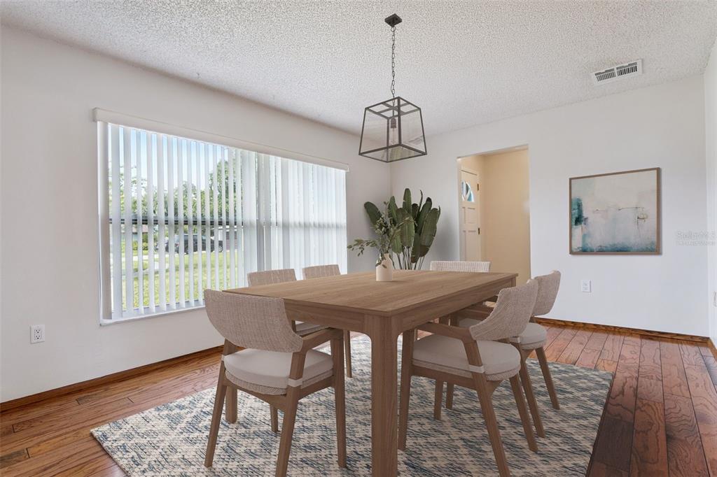 An empty room features hardwood flooring, a ceiling fan, and a large window with blinds — 4101 PLAYA COURT, BELLE ISLE, FL