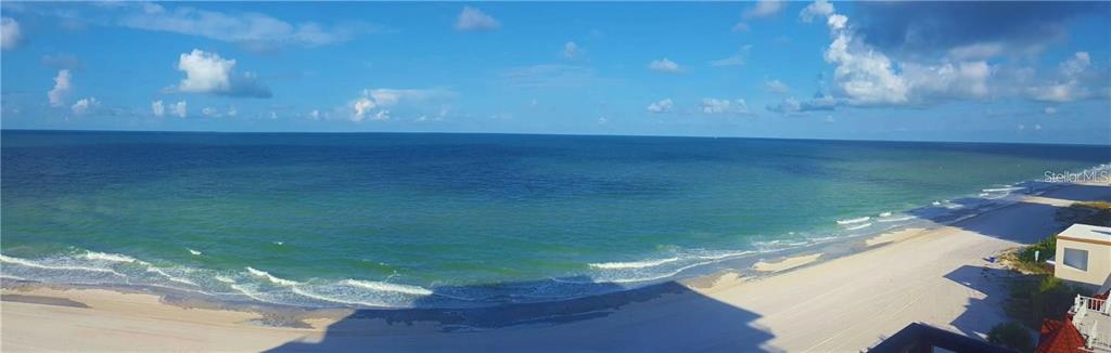 A panoramic view of a sandy beach and the ocean from an elevated balcony — 15316 GULF BOULEVARD UNIT 604, MADEIRA BEACH, FL