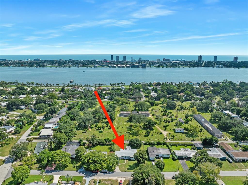 An aerial view shows a residential house with a red arrow pointing toward its roof — 1649 CORDOVA AVENUE, HOLLY HILL, FL