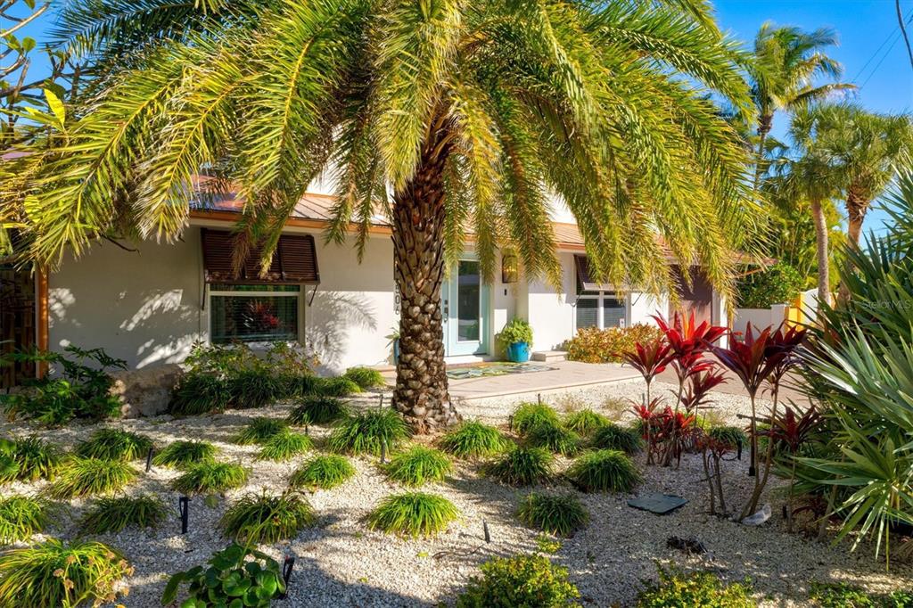 A white house with a palm tree in the front yard and gravel landscaping — 506 58TH STREET, HOLMES BEACH, FL