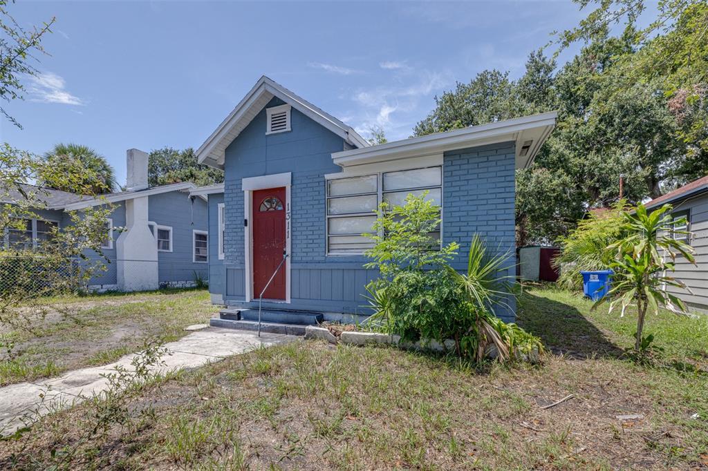 A blue brick house with a red front door and a concrete walkway — 1311 PRESCOTT STREET S, ST PETERSBURG, FL