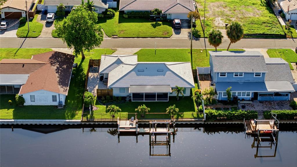 A single-story house with a white exterior, a tiled roof, and a two-car garage — 4152 13TH LANE NE, ST PETERSBURG, FL