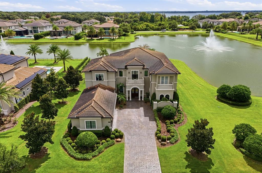 An aerial view of a two-story house with a tiled roof and a paved driveway — 3986 ISABELLA CIRCLE, WINDERMERE, FL