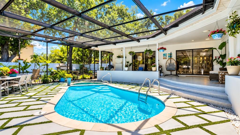 A bright living room features white tile floors, a large sectional sofa, and a front door — 1307 NORMANDY CIRCLE, PALM HARBOR, FL