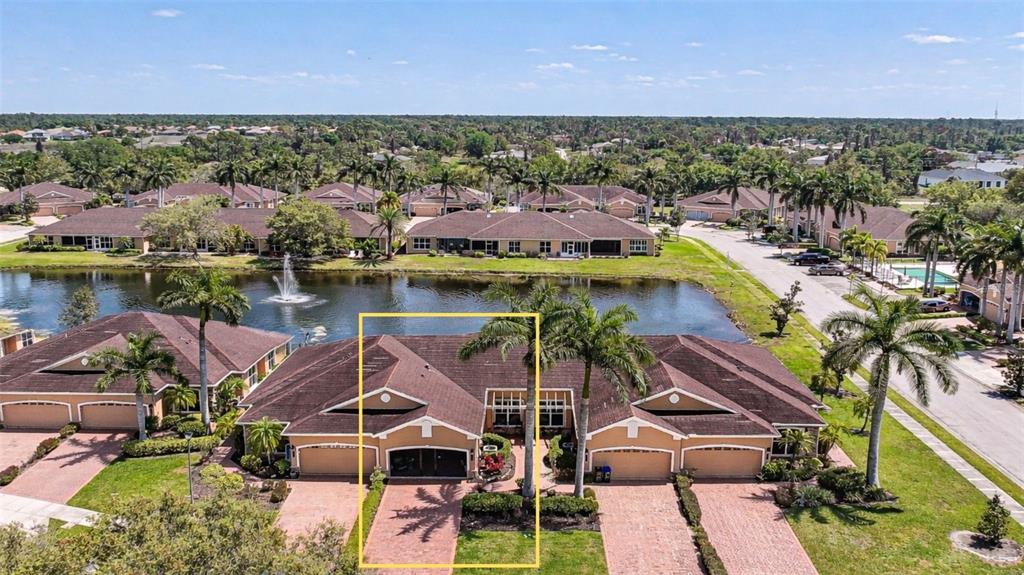 An aerial view shows a tan, single-story residential duplex with a brown roof and palm trees — 4691 TURNBERRY CIRCLE, NORTH PORT, FL