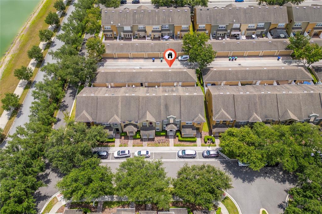 An aerial view shows a row of townhomes with attached garages and a parking lot — 7723 FAIRGROVE AVENUE, WINDERMERE, FL