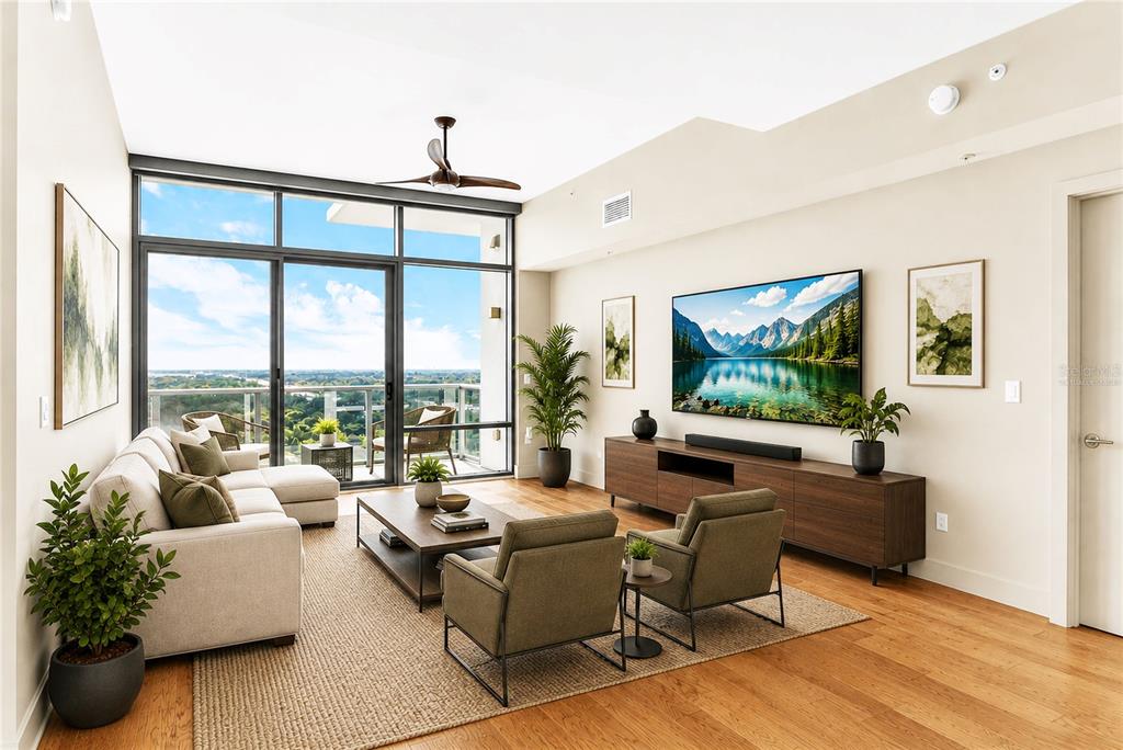 A modern living room features a sectional sofa, two armchairs, a television, and floor-to-ceiling windows — 260 S OSCEOLA AVENUE UNIT 1602, ORLANDO, FL